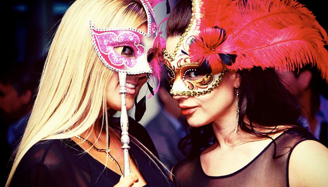 Two Penthouse girls in masks at a strip club party photo